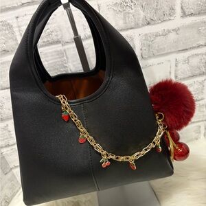 Elegant Black Handbag with Gold Chain and Red Accents